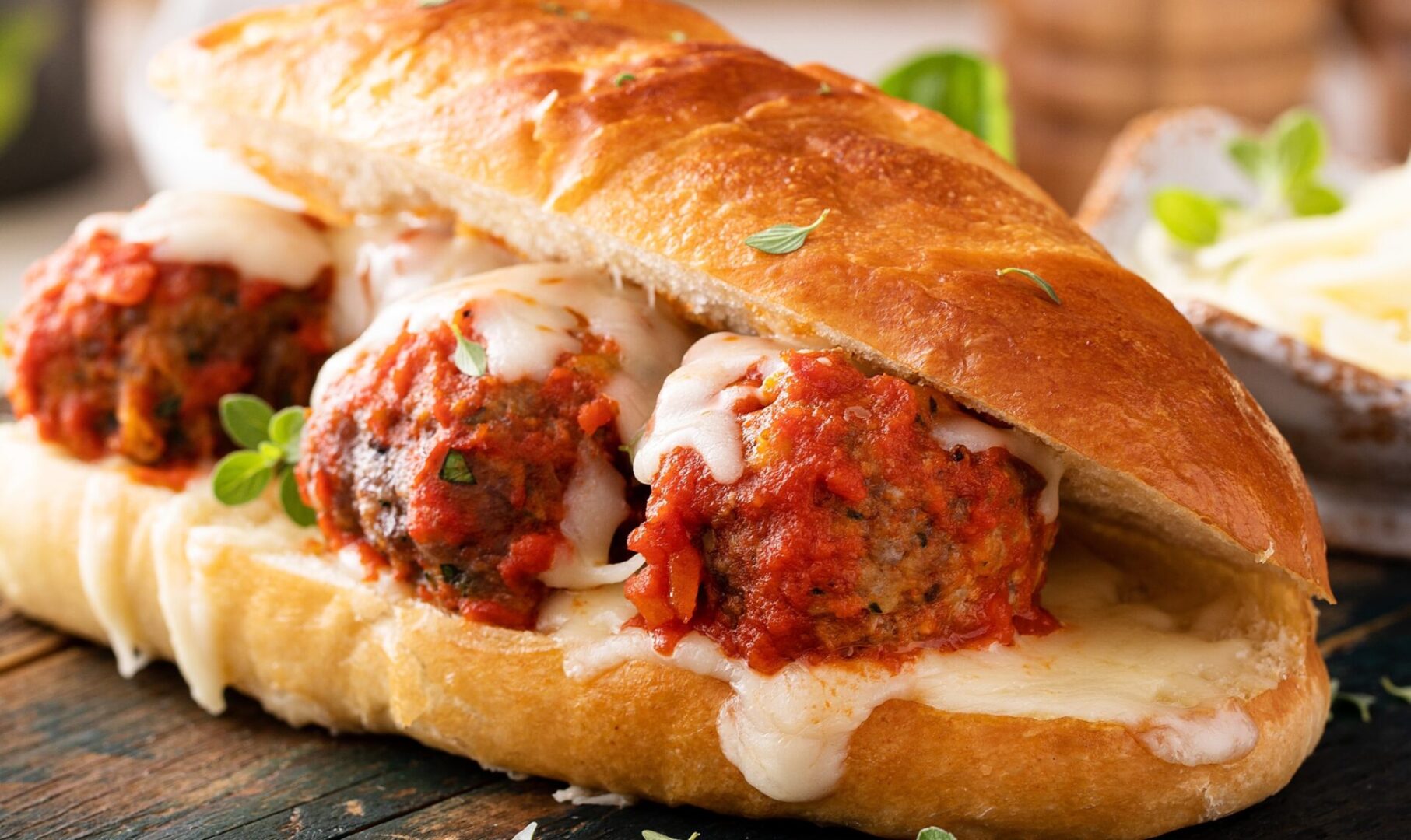 Meatball,Sub,Sandwich,With,Marinara,And,Mozzarella,And,Fresh,Herbs